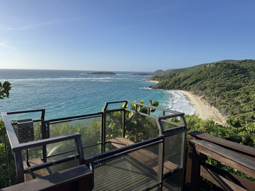 Hill Hiker Outdoor Elevator Trolley Car at top landing overlooking a sand beach on a tropical island shoreline