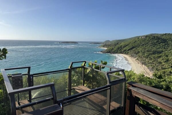 Hill Hiker Outdoor Elevator Trolley Car at top landing overlooking a sand beach on a tropical island shoreline