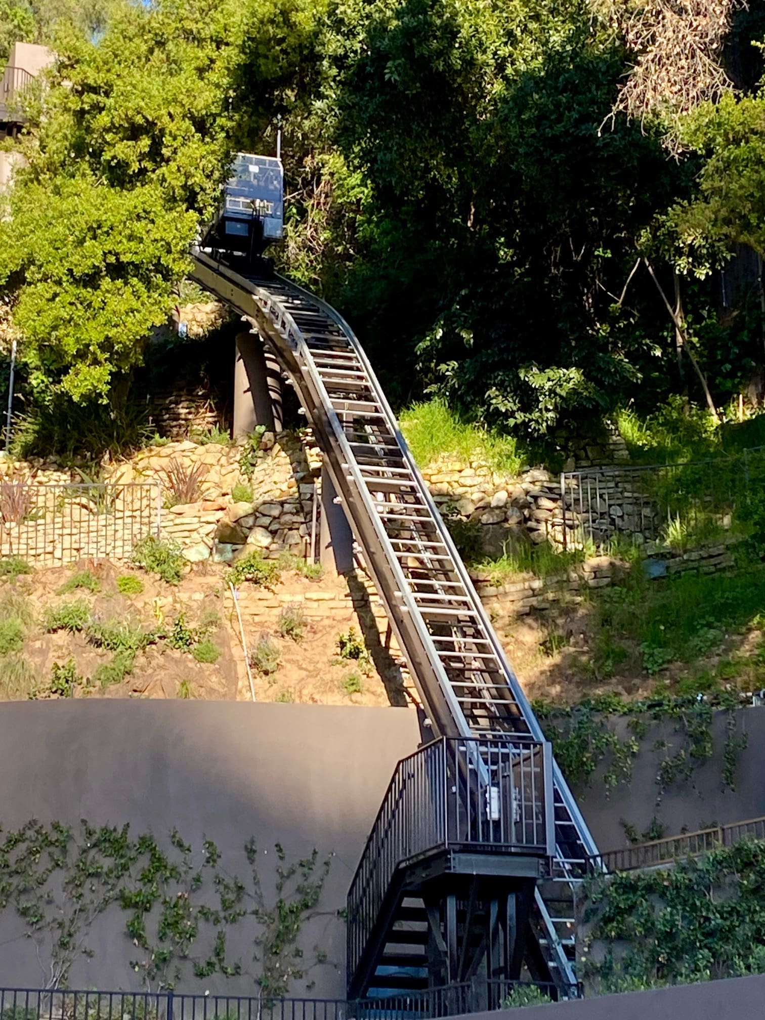Private funicular on special curved elevator rail track conturing to the hillside in California