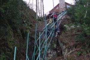 Hill Hiker installers hanging rail on a steep cliff with a hoist system for an incline cliff tram
