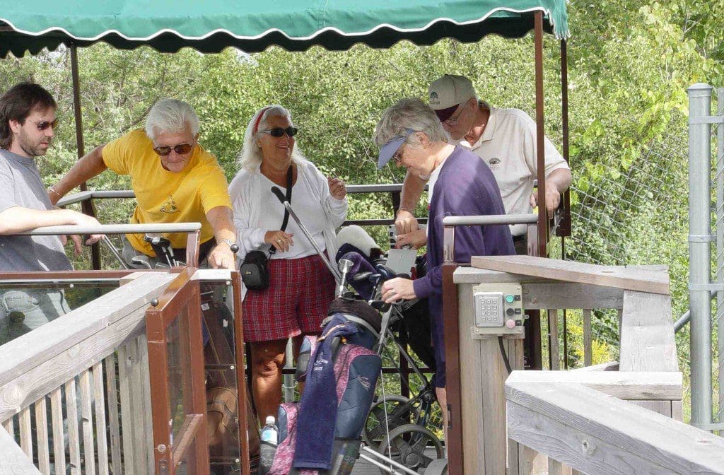 Golfers loading Onto A Hillside Tram